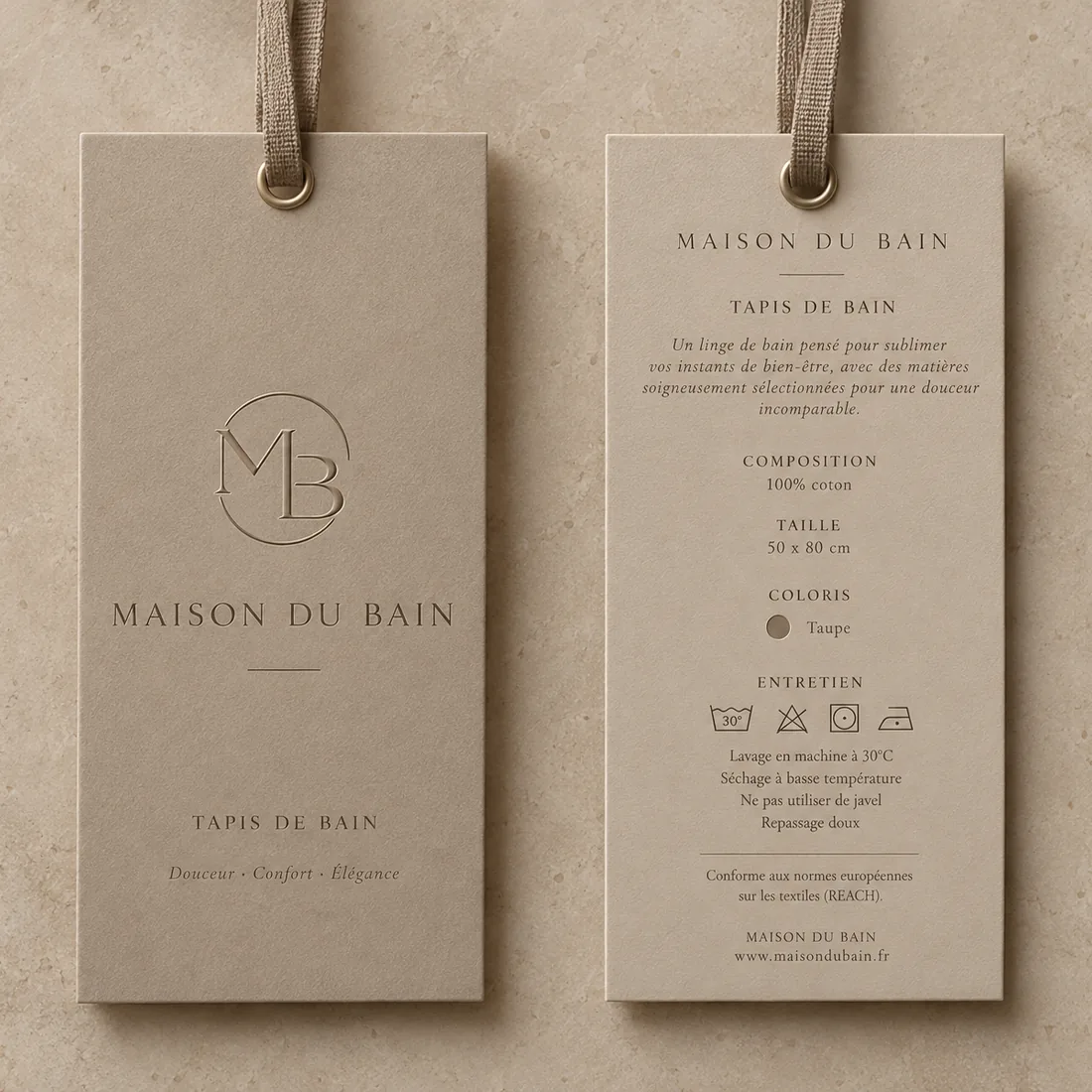 Étiquettes produit MDB en carton beige, recto avec le monogramme et verso avec composition et entretien